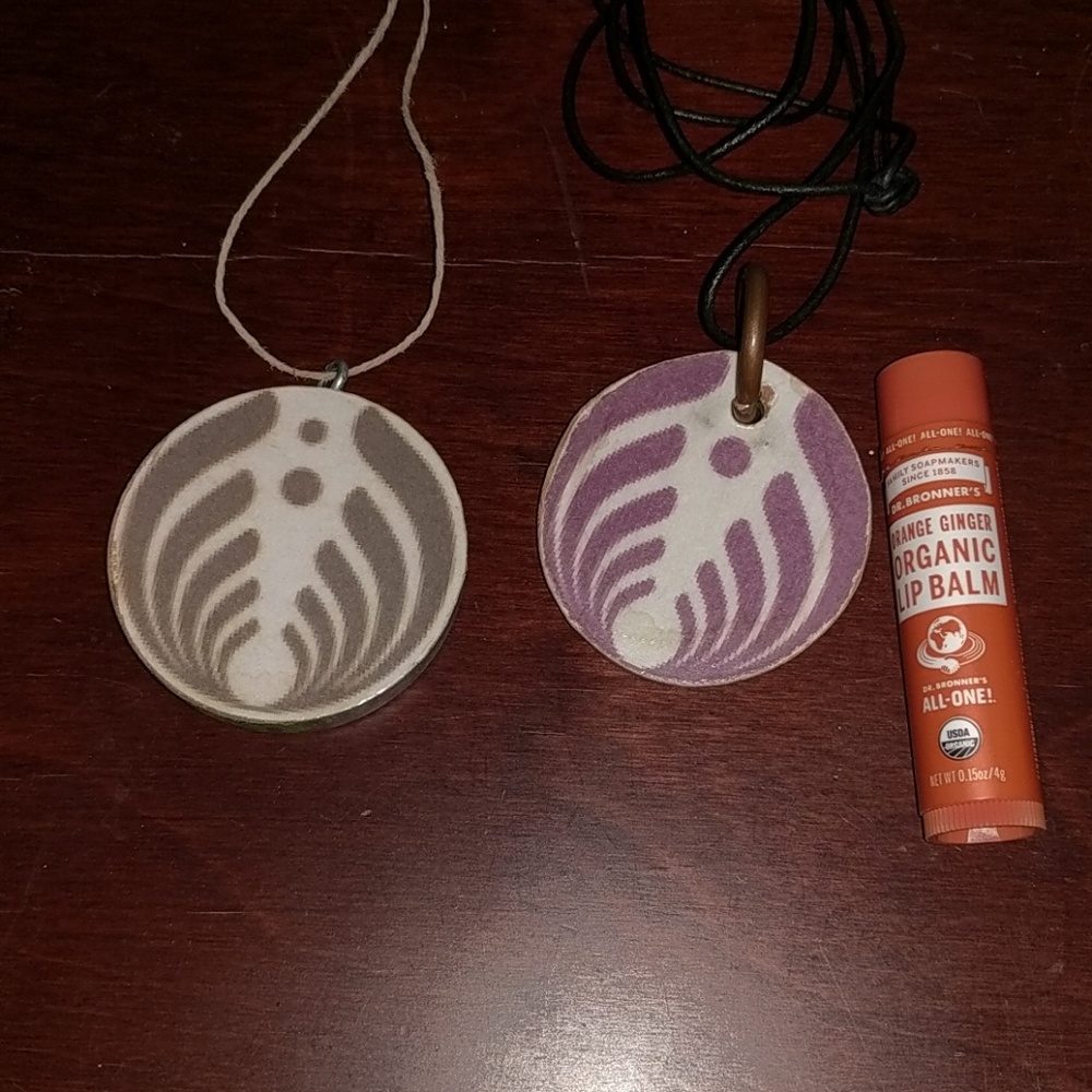 Two Bassnectar necklace pendants